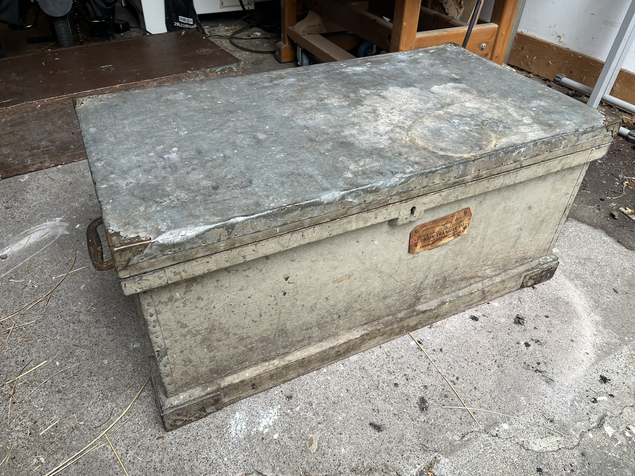 The large tool chest, painted grey, with a tin-covered lid