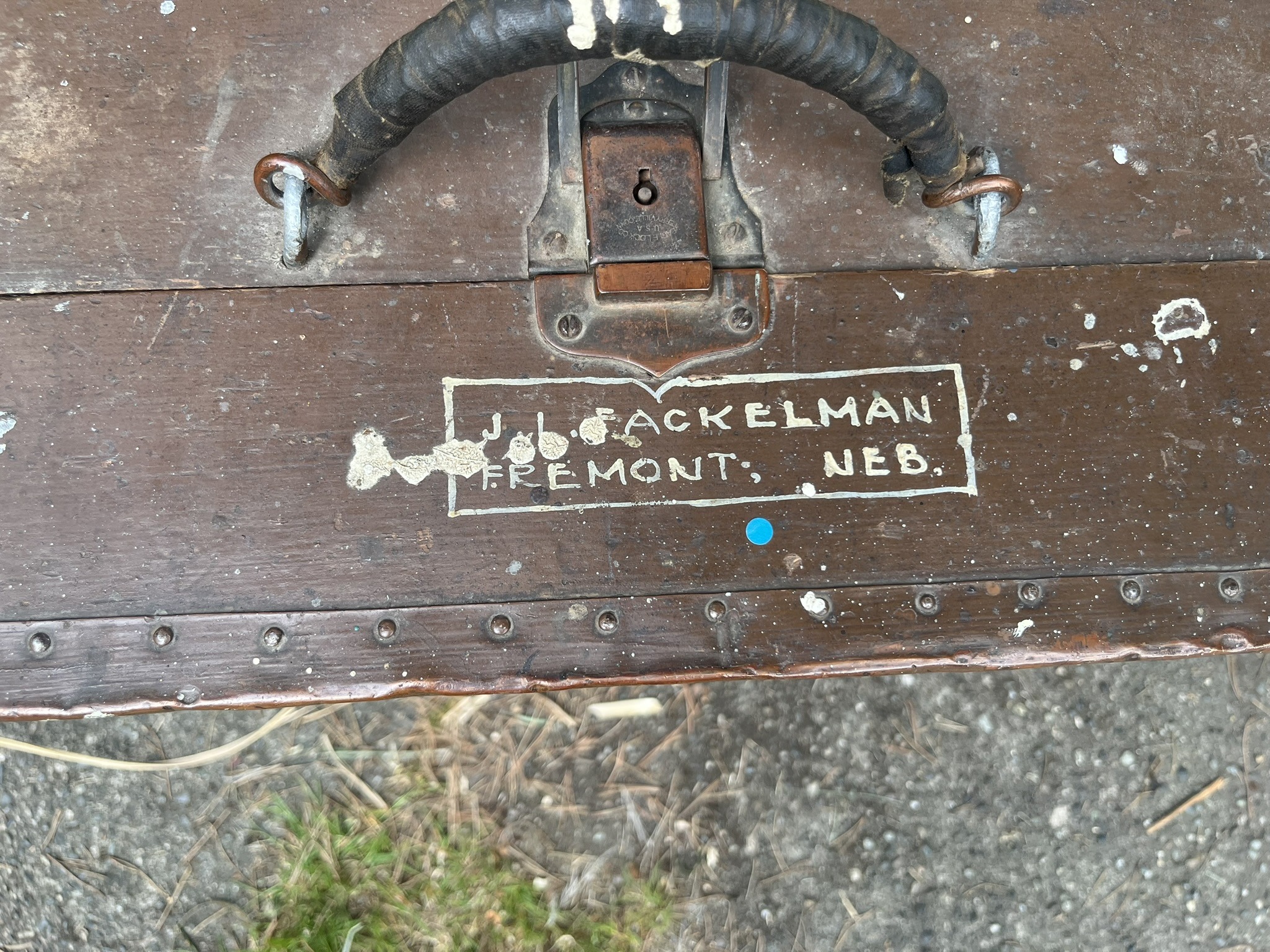 Close-up of a hand-painted box on the brown chest reading J.L. Fackelman, Fremont, Neb.