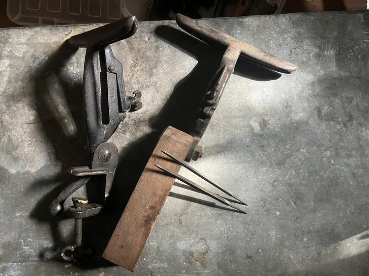 Two cast iron saw vises and a pair of long dividers
