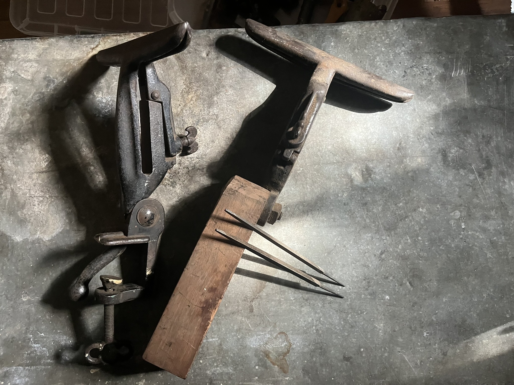 Two cast iron saw vises and a pair of long dividers