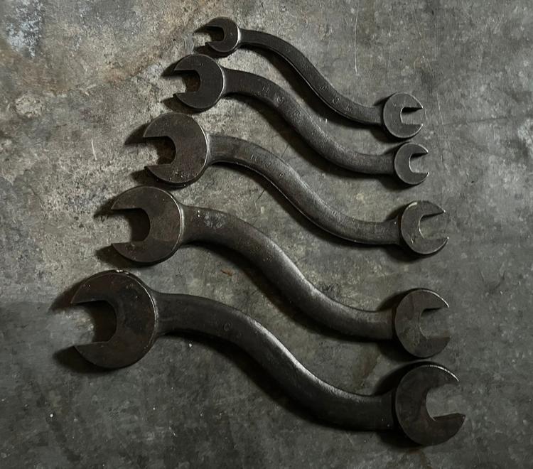 Five S-shaped open-end wrenches arranged by size